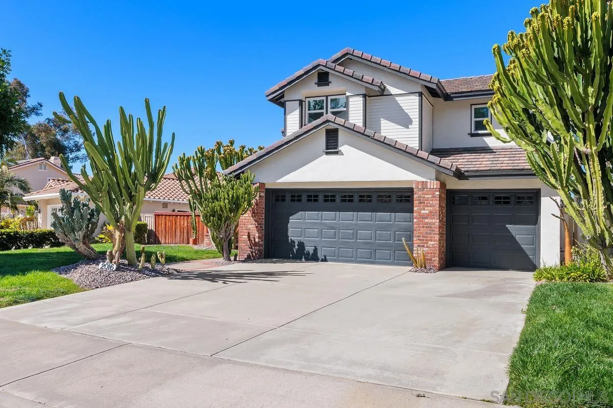 2016 Sequoia Street San Marcos, CA 92078 - Photo 5 of 50 a front view of a house with a yard and garage