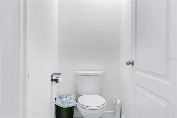 a white toilet sitting next to a bathroom sink