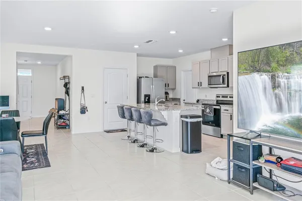 a kitchen with stainless steel appliances kitchen island granite countertop a sink and cabinets