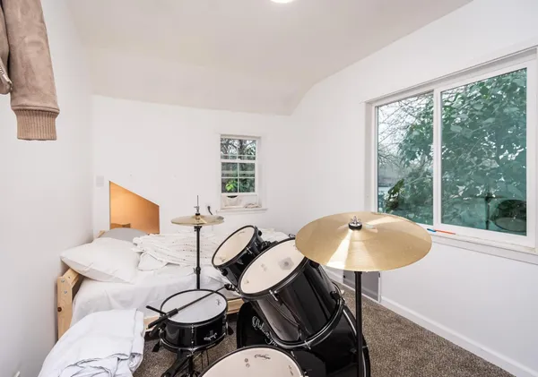 a living room with furniture a air conditioner and a window