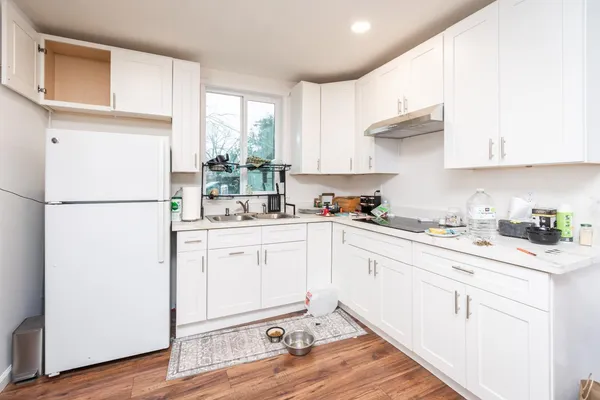 a open kitchen with sink cabinets and wooden floor