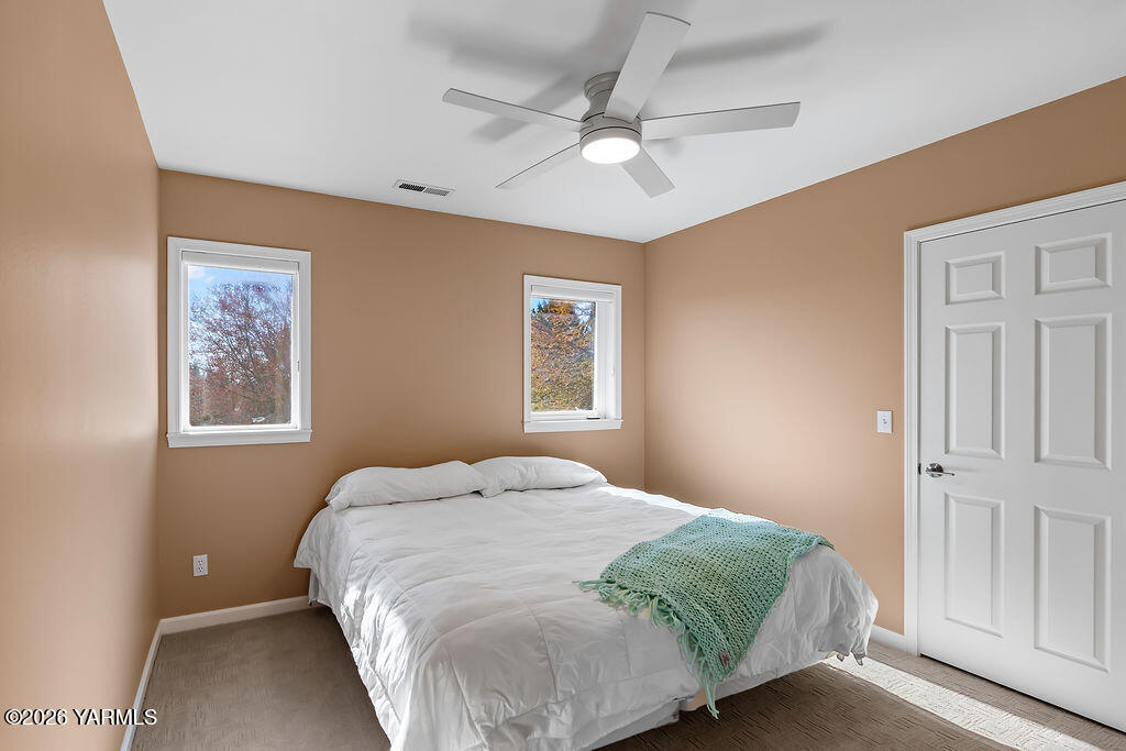 6810 Ravens Gate Way Yakima, WA 98908 - Photo 30 of 49 a bedroom with a large bed and a window