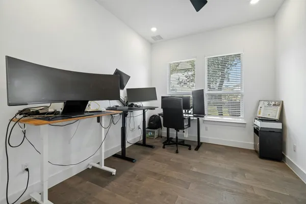 a view of a workspace with furniture and a window