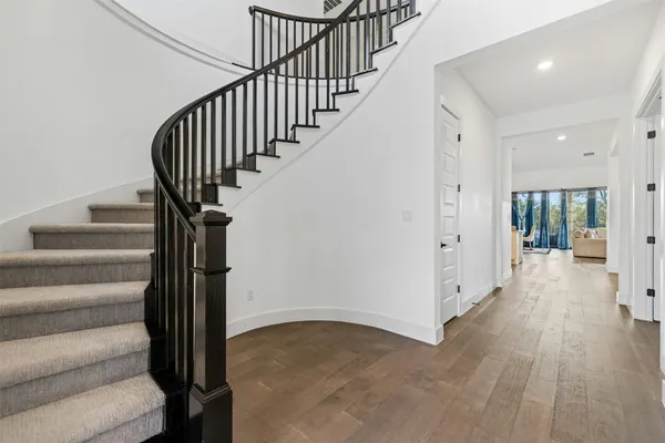 a view of entryway with wooden floor and stairs