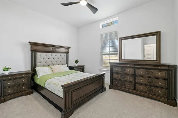 a bedroom with a bed and a dresser