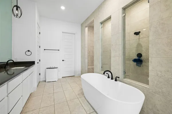 a bathroom with a bathtub and a sink