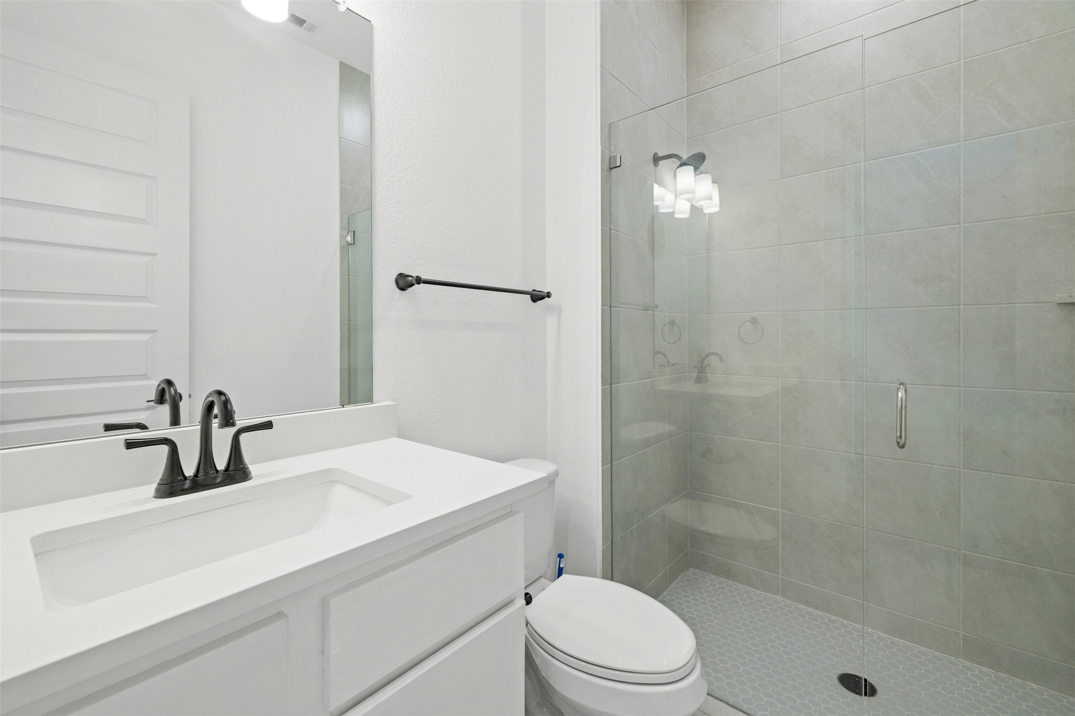 172 Shady Hl Loop Liberty Hill, TX 78642 - Photo 19 of 30 a bathroom with a sink a toilet and shower