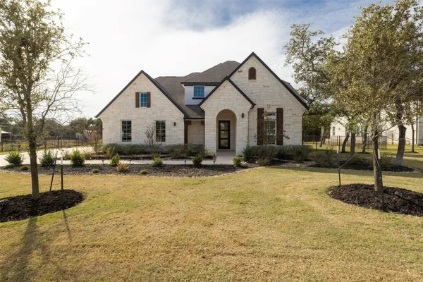 a front view of a house with a yard
