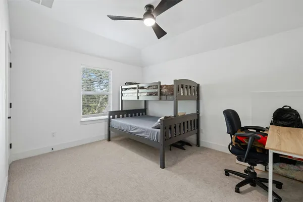 a bedroom with furniture and a window