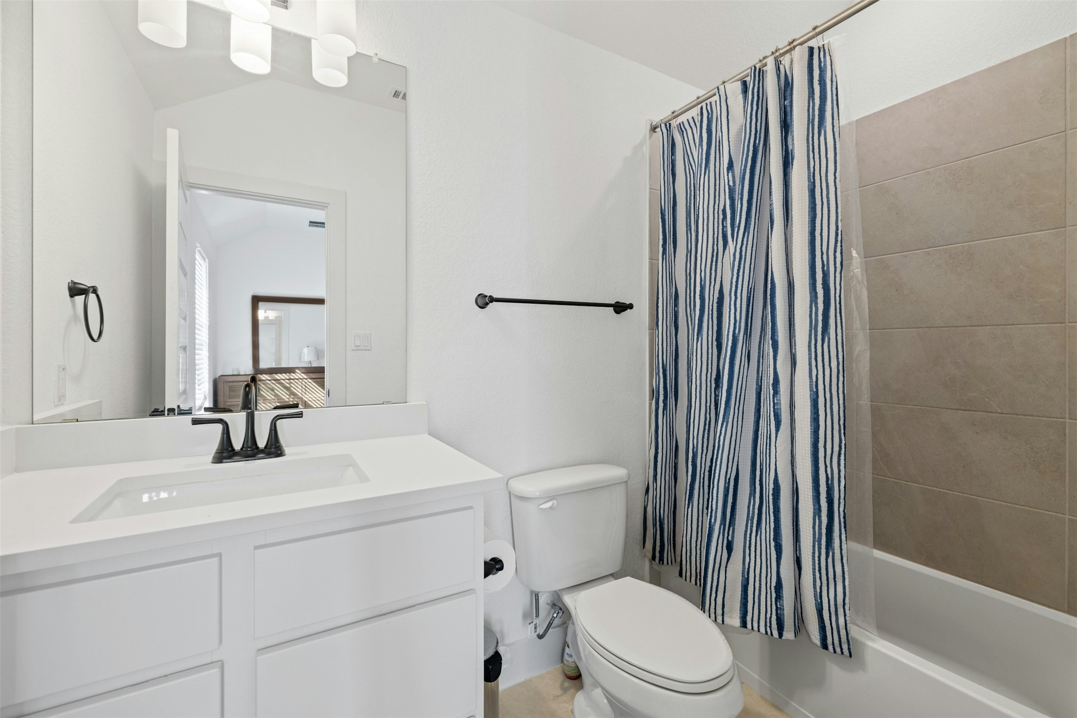 172 Shady Hl Loop Liberty Hill, TX 78642 - Photo 23 of 30 a bathroom with a sink a toilet and shower