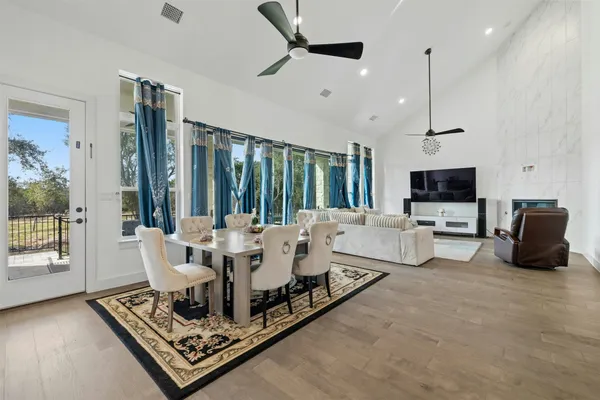a living room with furniture a large window and a flat screen tv