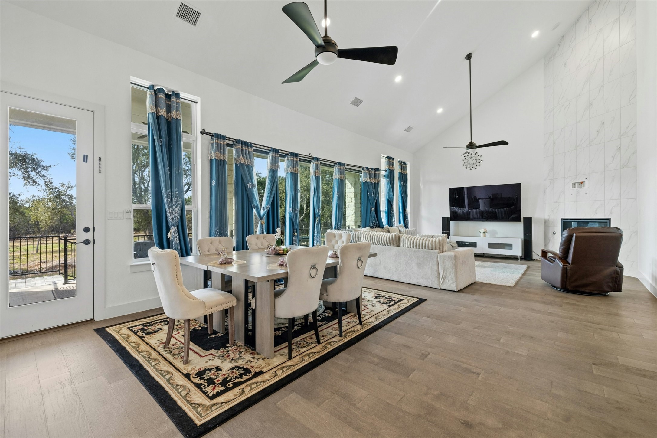 172 Shady Hl Loop Liberty Hill, TX 78642 - Photo 5 of 30 a living room with furniture a large window and a flat screen tv