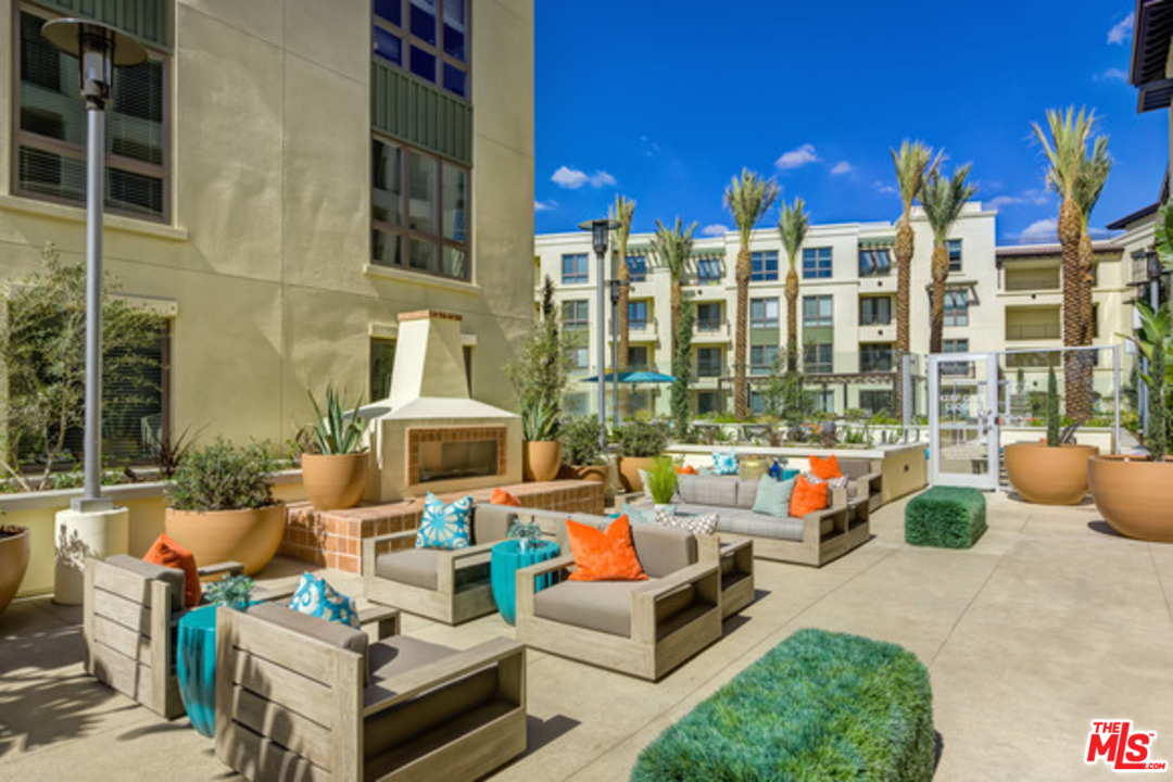 75 West Walnut Street, Unit 434 Pasadena, CA 91103 - Photo 13 of 22 a view of a building with couches chairs and a potted plant