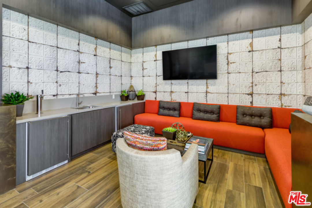 75 West Walnut Street, Unit 434 Pasadena, CA 91103 - Photo 21 of 22 a living room with furniture and a flat screen tv