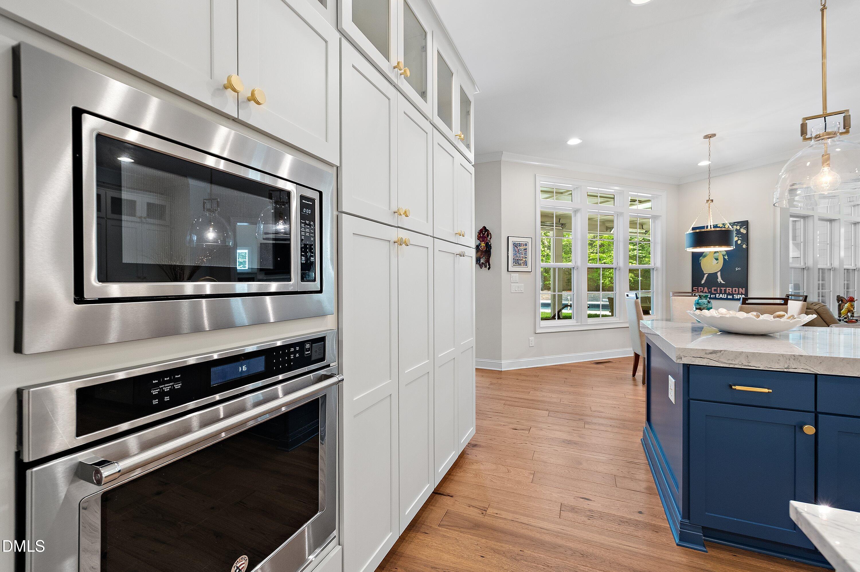 1536 Rock Dove Way Raleigh, NC 27614 - Photo 25 of 100 a kitchen with stainless steel appliances a stove microwave and sink