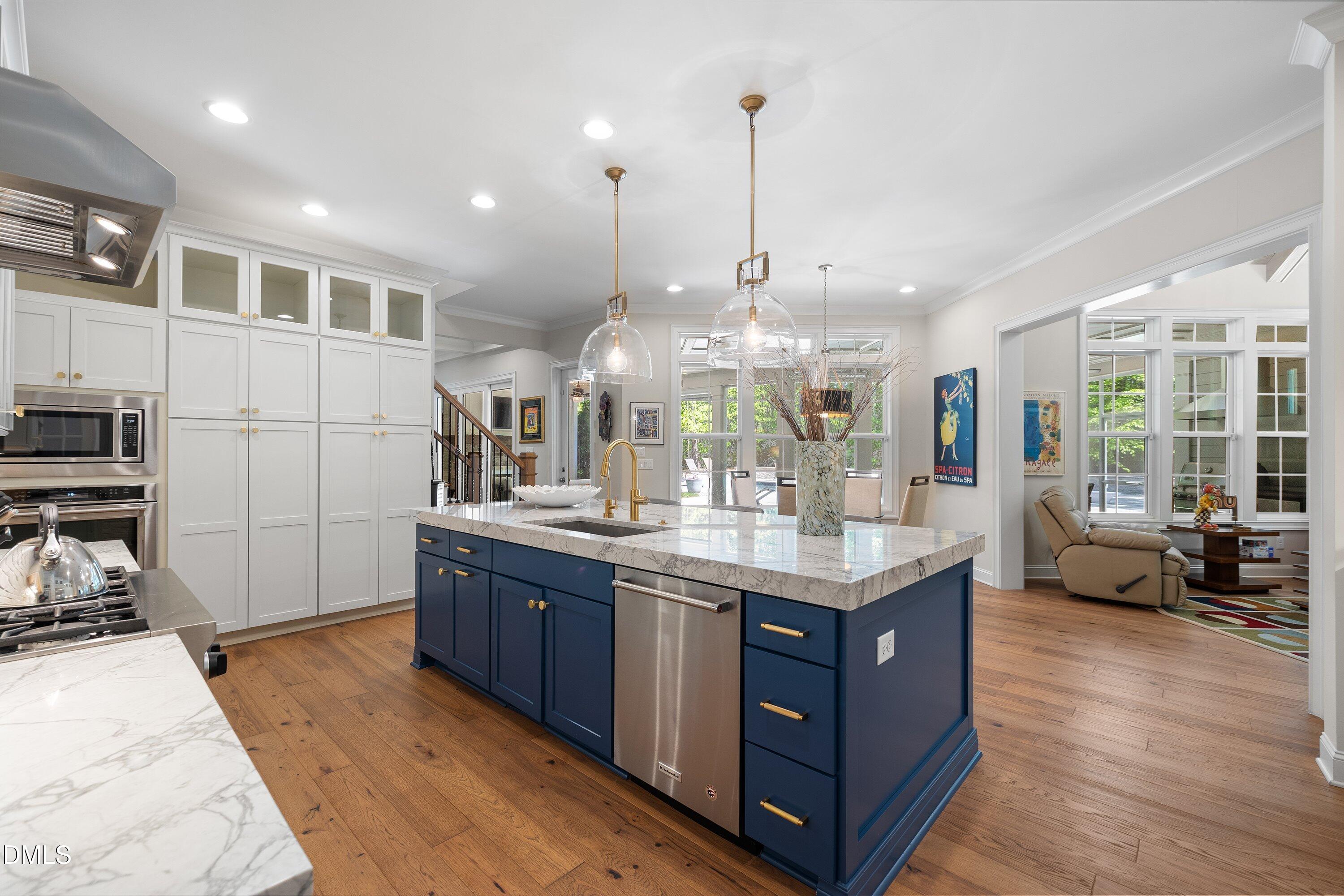1536 Rock Dove Way Raleigh, NC 27614 - Photo 30 of 100 a kitchen with stainless steel appliances granite countertop sink stove and wooden floor