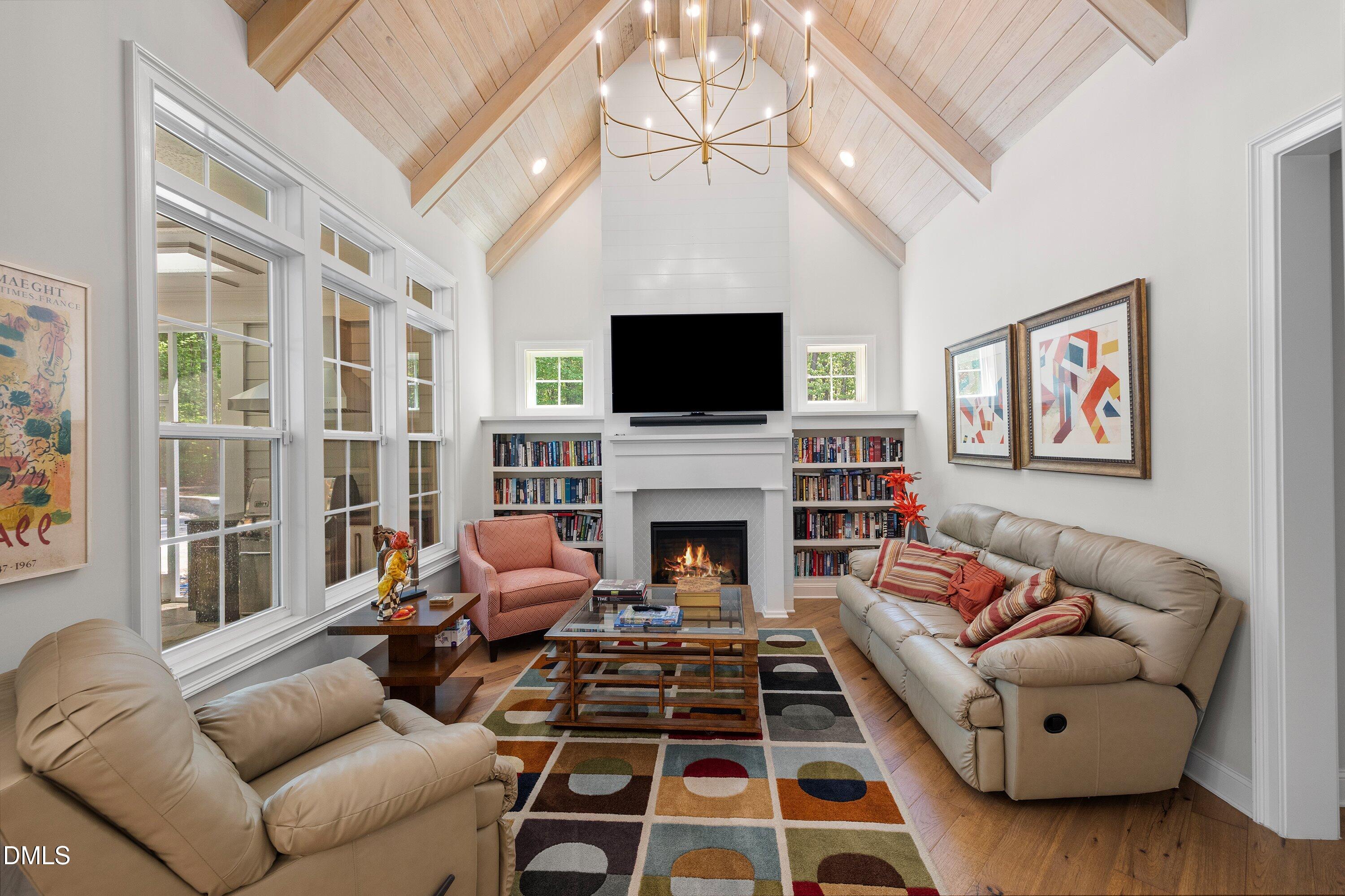 1536 Rock Dove Way Raleigh, NC 27614 - Photo 35 of 100 a living room with furniture a fireplace and a flat screen tv