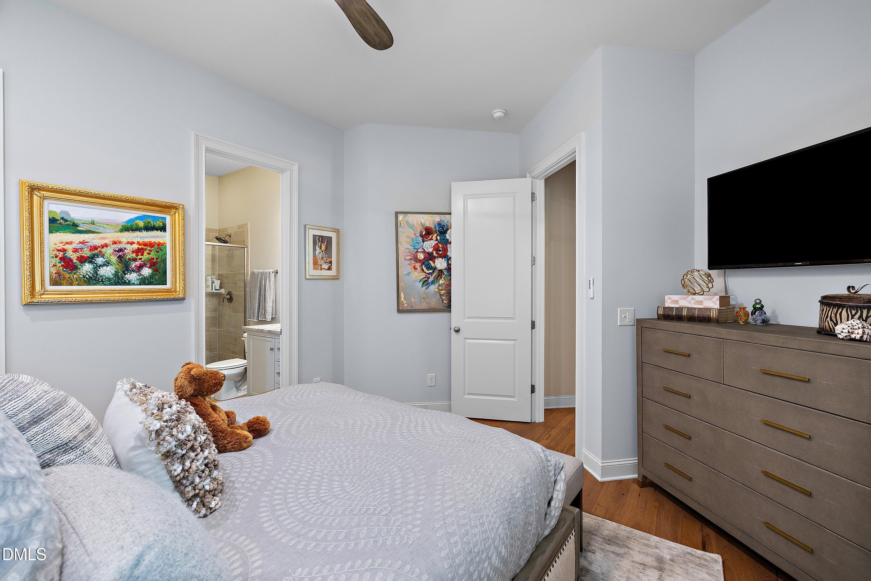 1536 Rock Dove Way Raleigh, NC 27614 - Photo 40 of 100 a bedroom with a bed and a flat screen tv