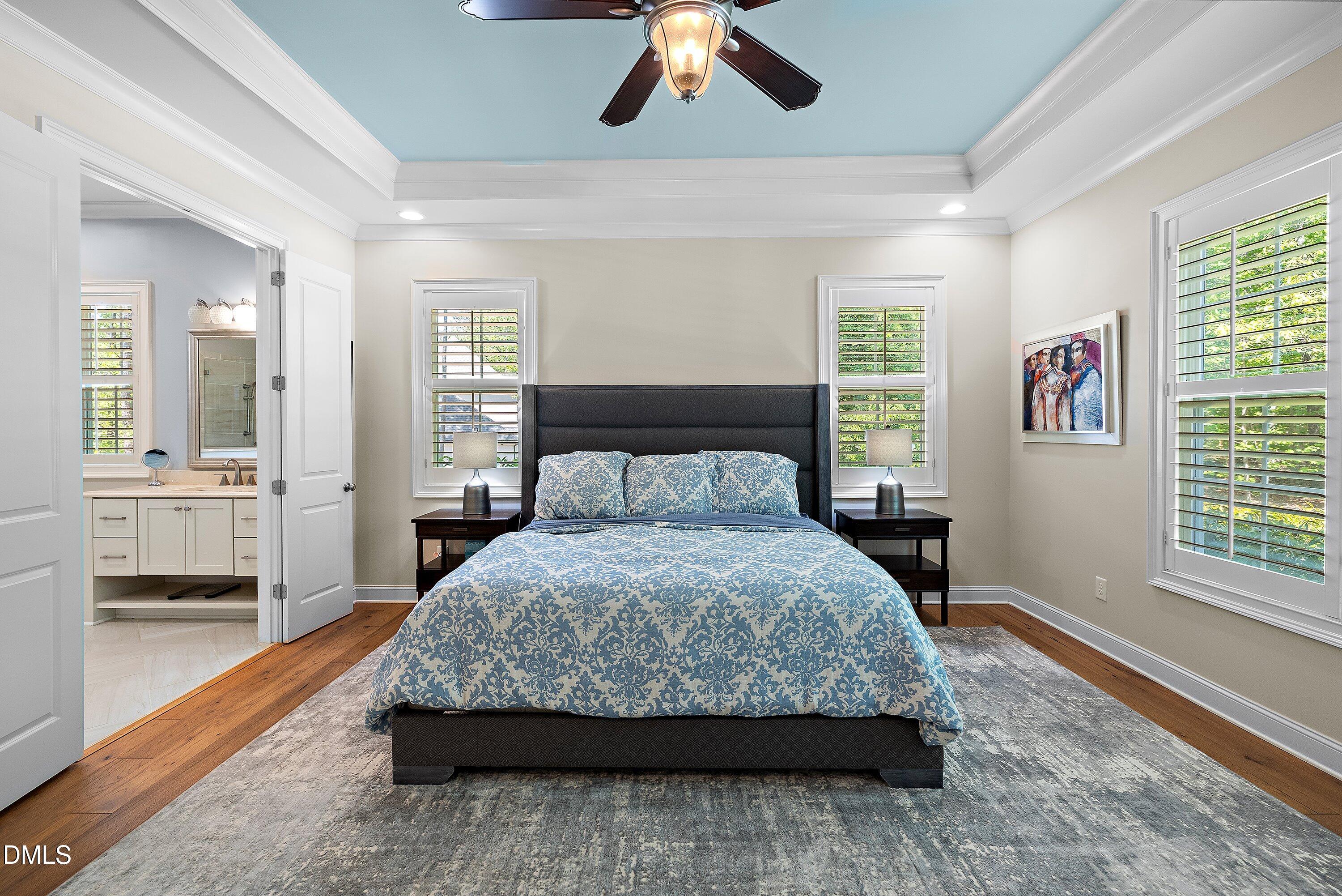 1536 Rock Dove Way Raleigh, NC 27614 - Photo 49 of 100 a bedroom with a large bed and a chandelier