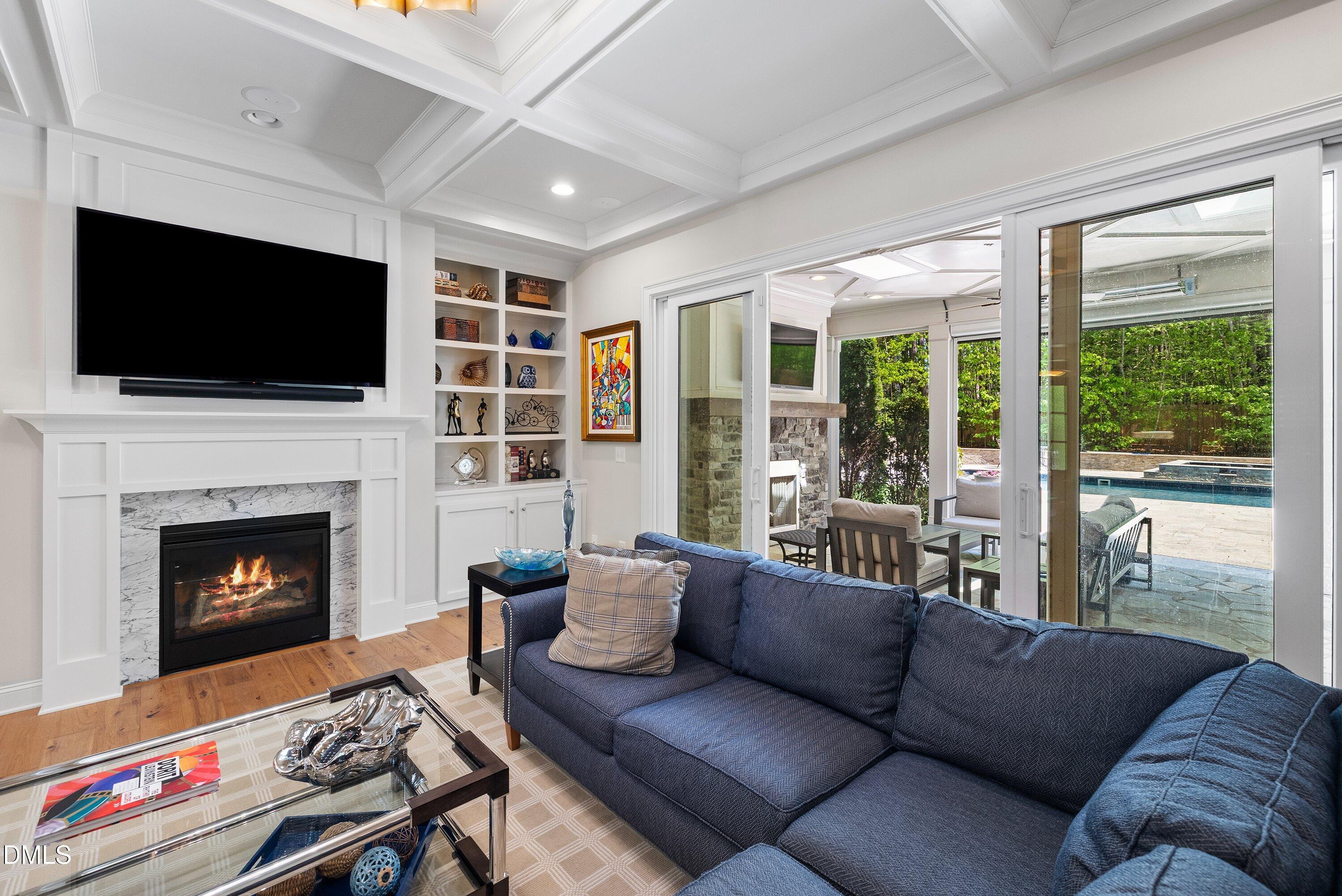 1536 Rock Dove Way Raleigh, NC 27614 - Photo 59 of 100 a living room with furniture a flat screen tv and a fireplace