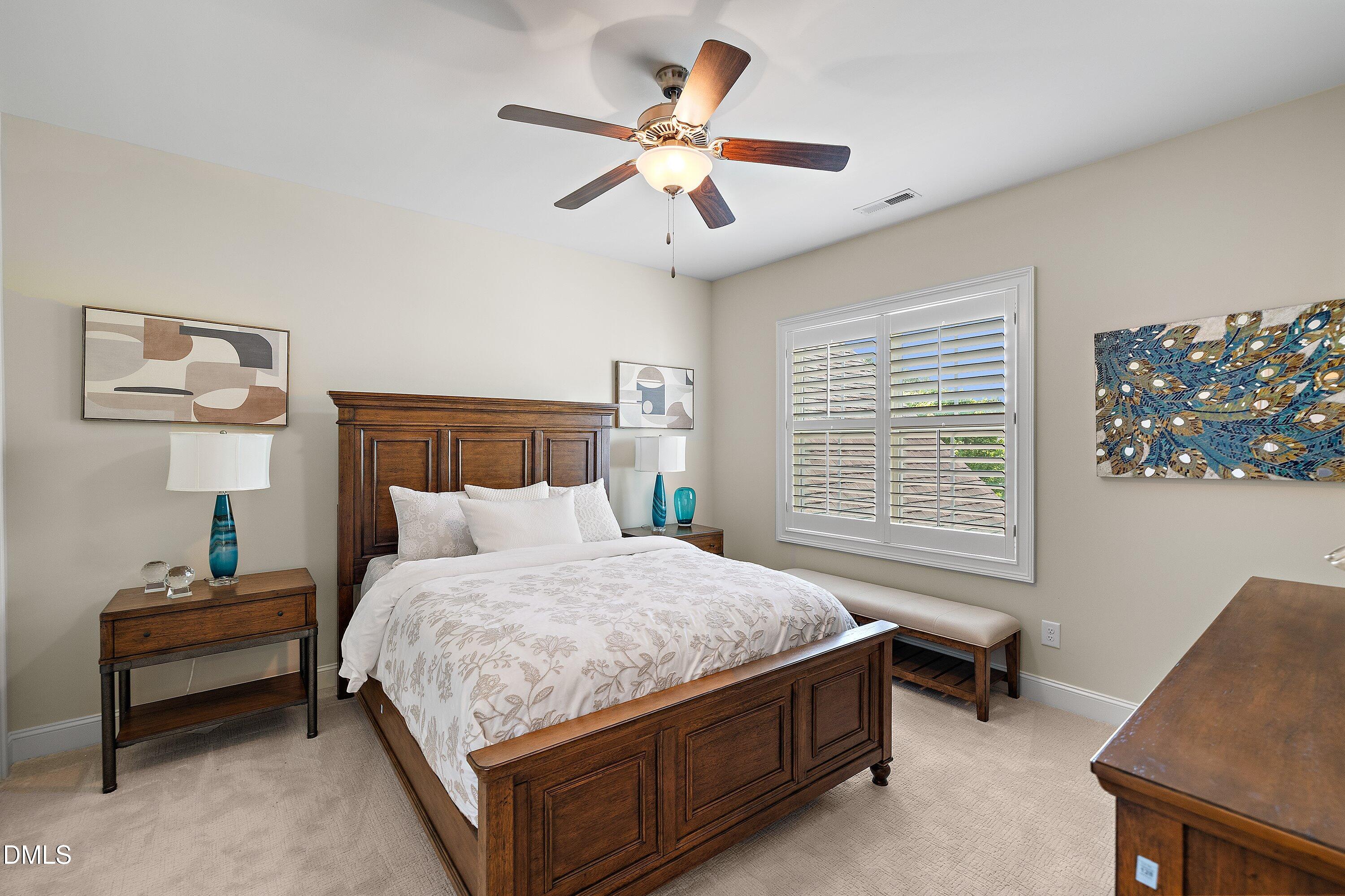 1536 Rock Dove Way Raleigh, NC 27614 - Photo 71 of 100 a bedroom with a bed and a chandelier