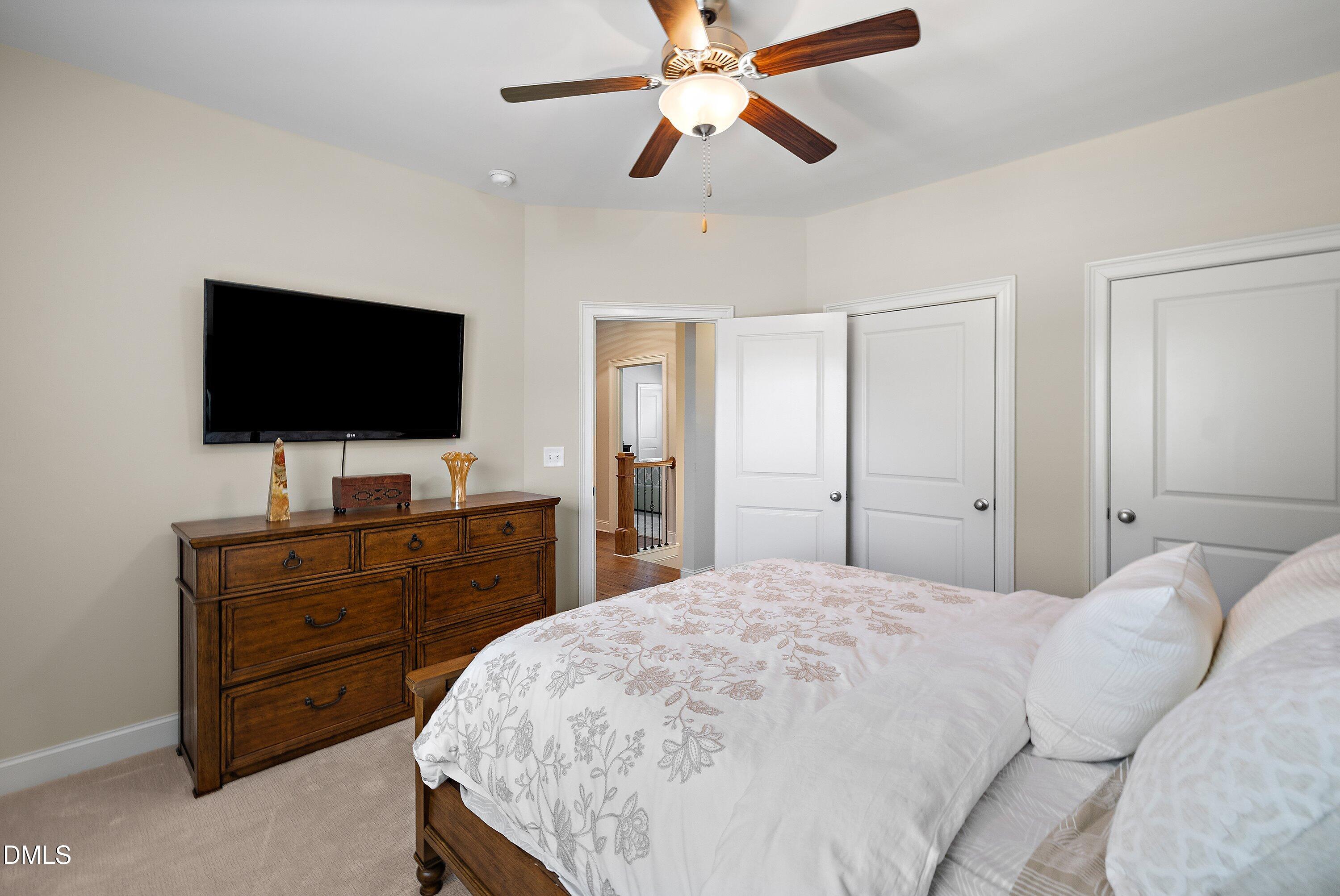 1536 Rock Dove Way Raleigh, NC 27614 - Photo 72 of 100 a bedroom with a bed and a flat screen tv on dresser