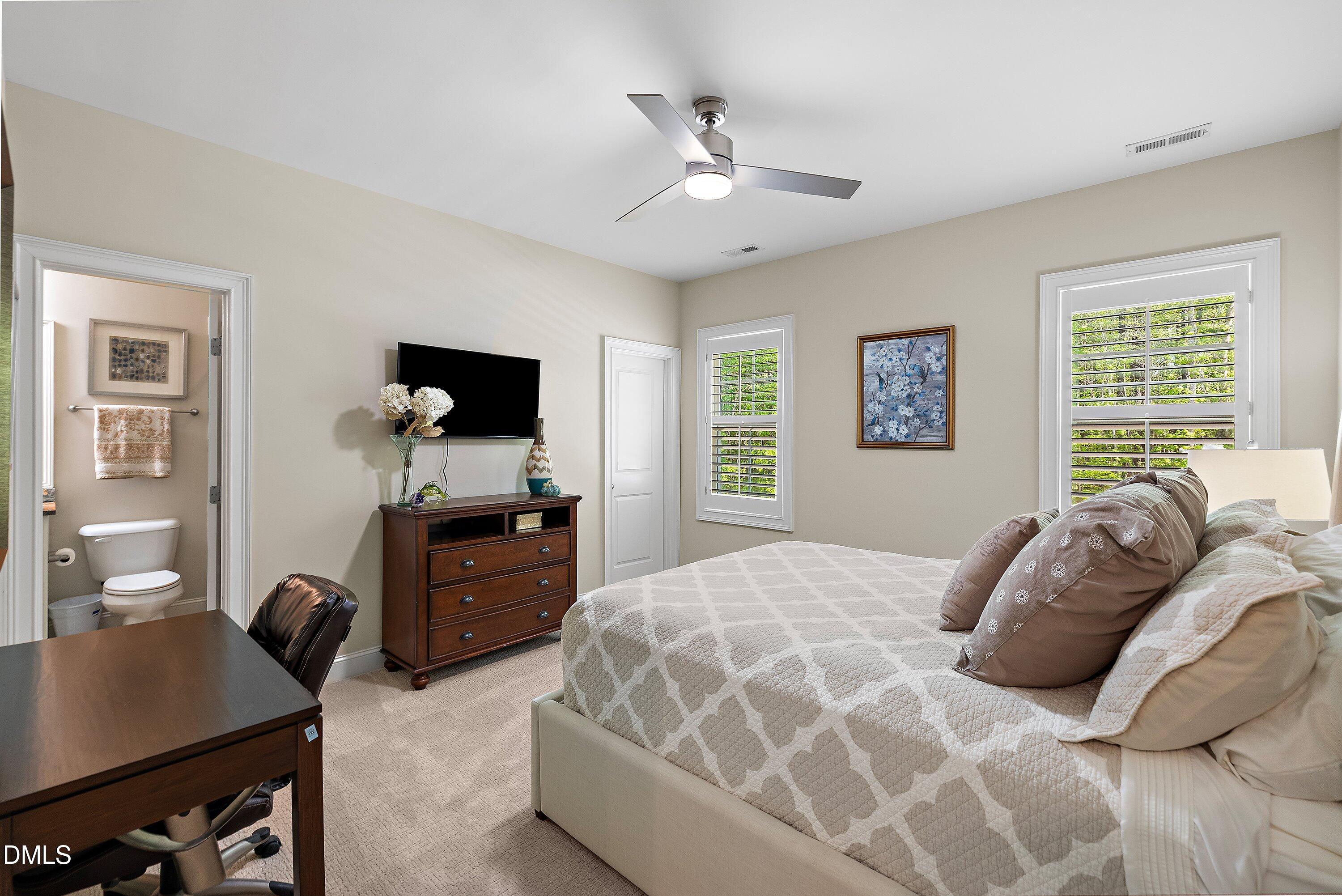 1536 Rock Dove Way Raleigh, NC 27614 - Photo 73 of 100 a bedroom with a bed and a flat screen tv