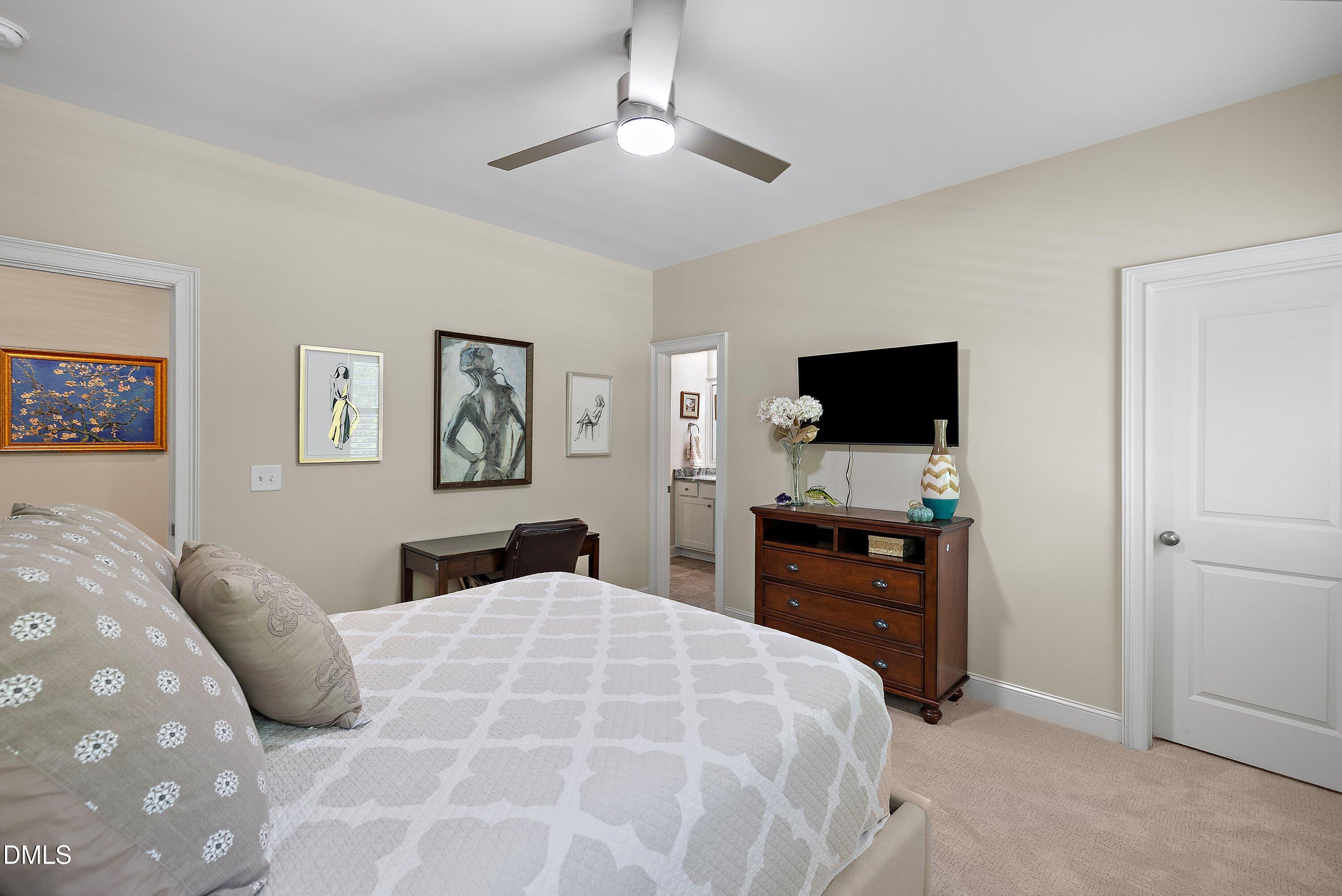 1536 Rock Dove Way Raleigh, NC 27614 - Photo 74 of 100 a bedroom with a large bed and a flat tv screen on dresser
