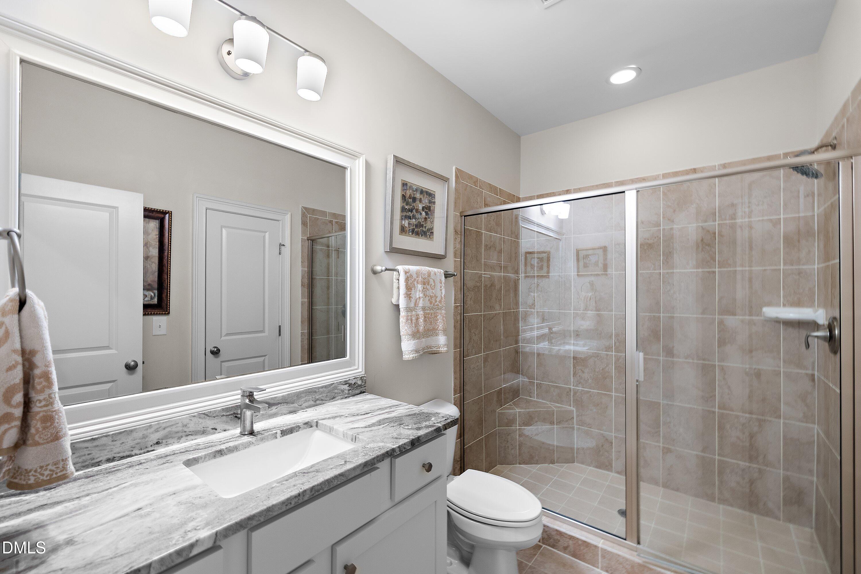 1536 Rock Dove Way Raleigh, NC 27614 - Photo 78 of 100 a bathroom with a granite countertop sink toilet and shower