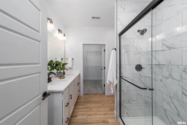a bathroom with a shower and a sink