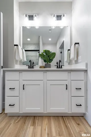 a bathroom with a sink vanity granite and a mirror