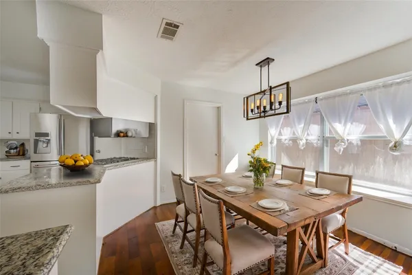 a view of a kitchen with wooden floor and a kitchen