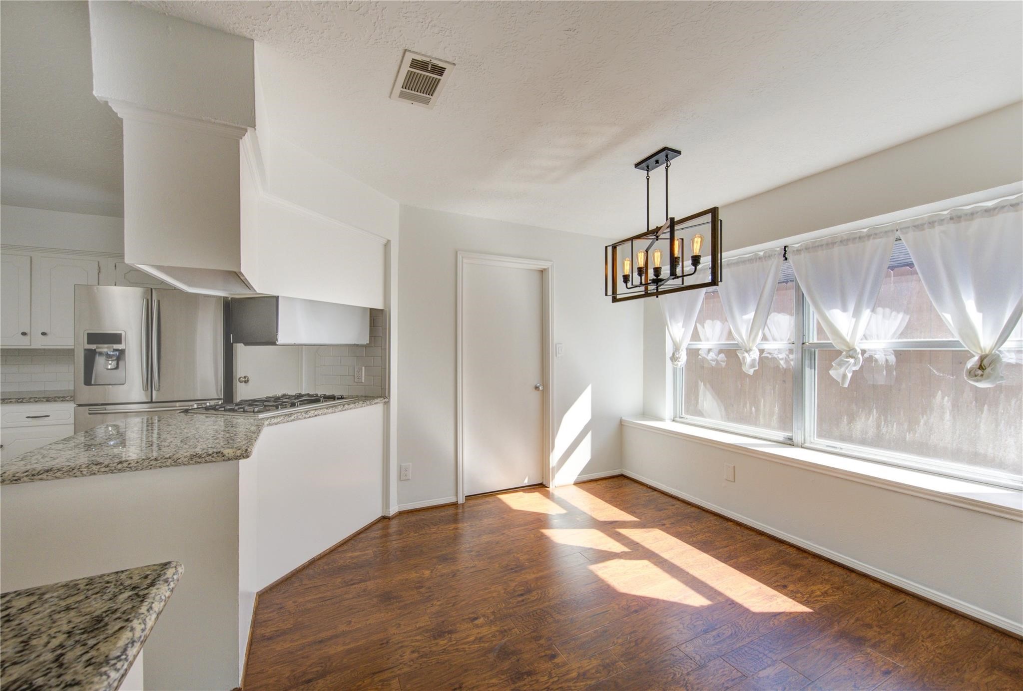 29115 Raestone Street Spring, TX 77386 - Photo 12 of 40 a view of a kitchen with wooden floor and a kitchen
