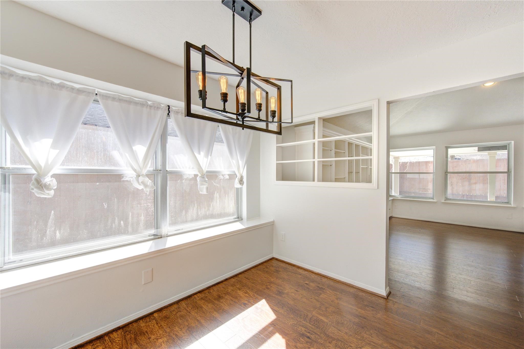 29115 Raestone Street Spring, TX 77386 - Photo 14 of 40 a view of an empty room with wooden floor and a window