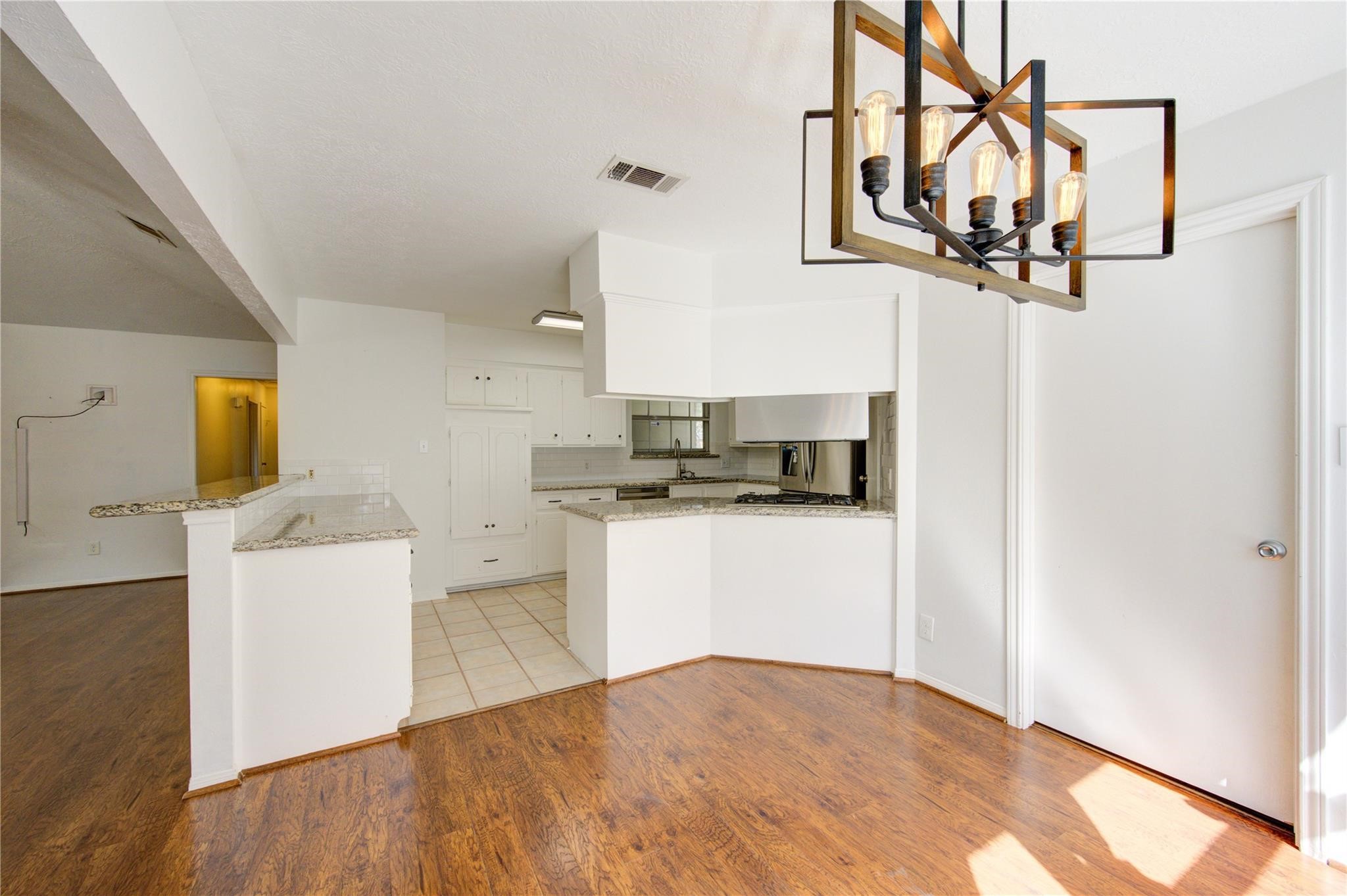 29115 Raestone Street Spring, TX 77386 - Photo 15 of 40 a kitchen with a refrigerator and white cabinets