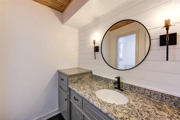 a bathroom with a sink a mirror and shower