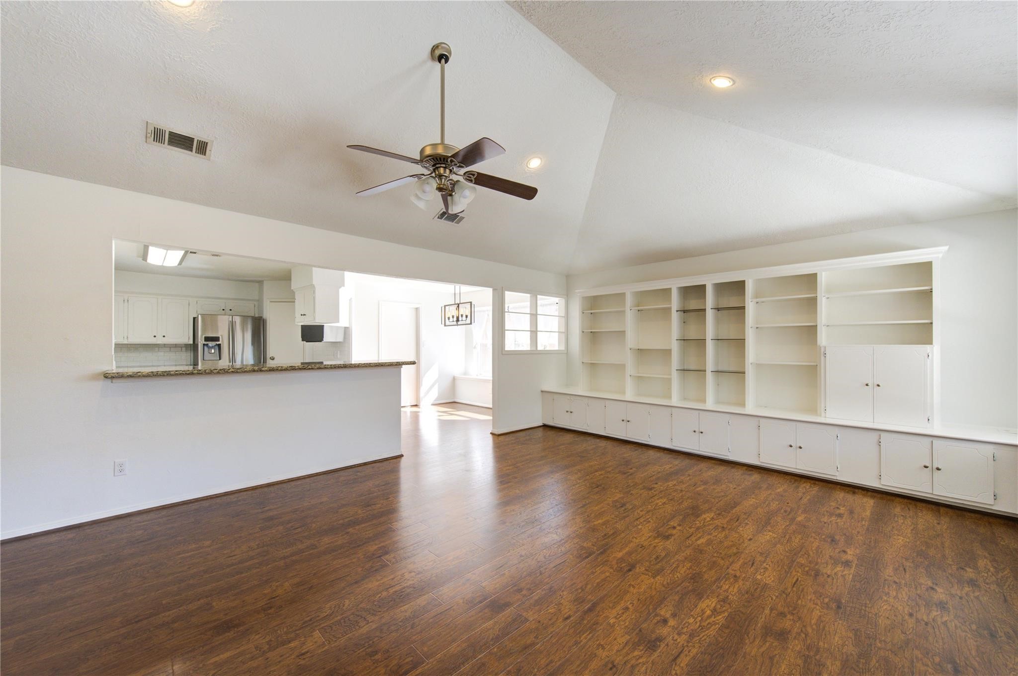 29115 Raestone Street Spring, TX 77386 - Photo 6 of 40 a view of an empty room with a window and wooden floor