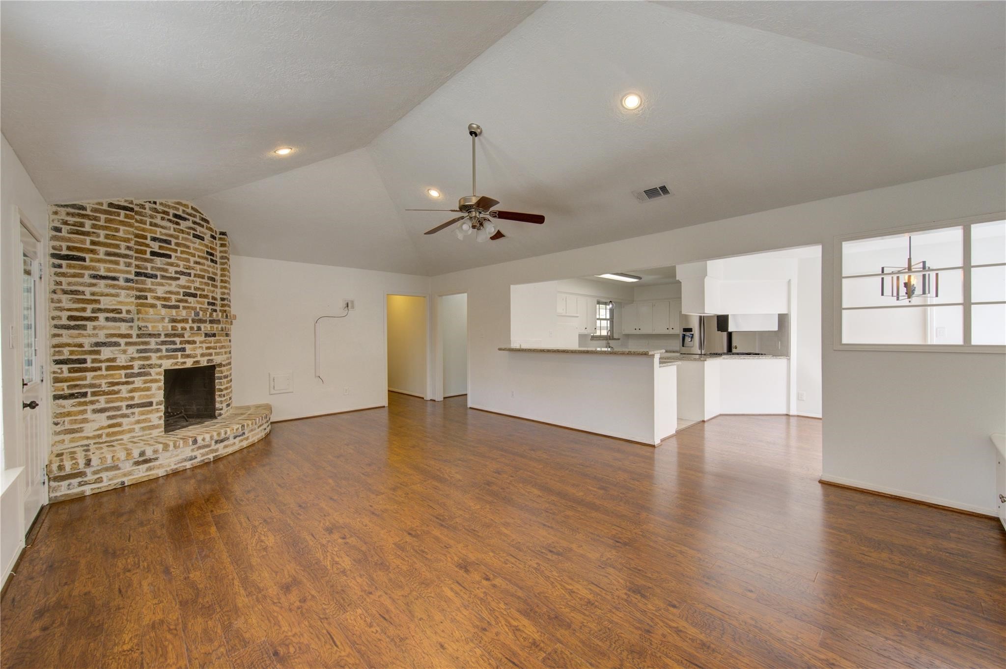 29115 Raestone Street Spring, TX 77386 - Photo 9 of 40 a view of empty room with wooden floor and fireplace