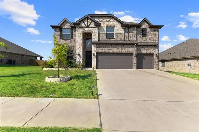 a view of a house with a yard and garage