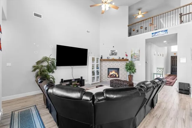 a living room with fireplace furniture and a flat screen tv