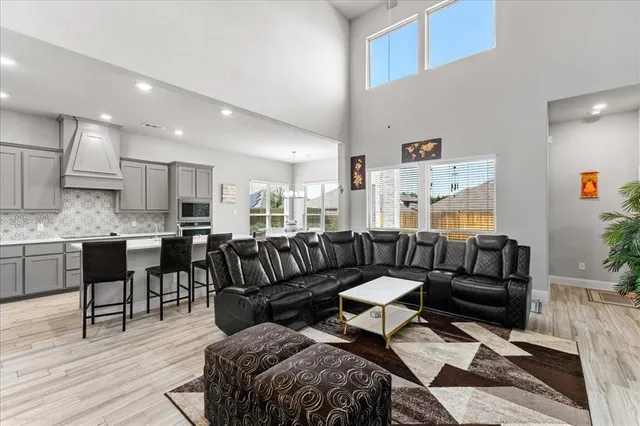 a living room with furniture and kitchen view