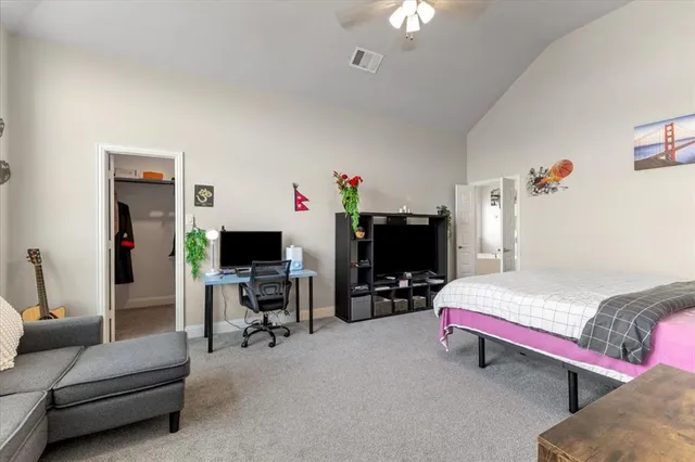 a bedroom with furniture and a flat screen tv