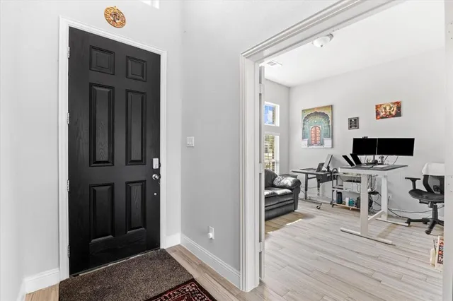 a view of a livingroom with workspace and a window