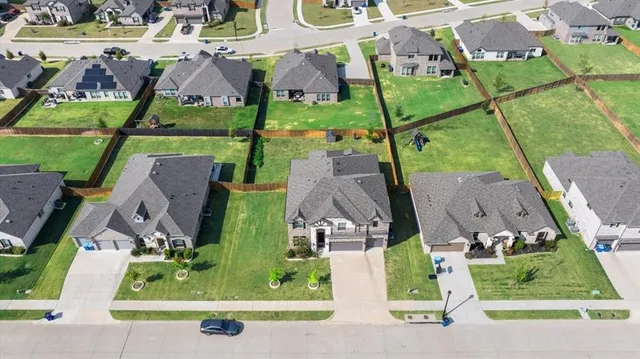 an aerial view of houses with outdoor space and parking