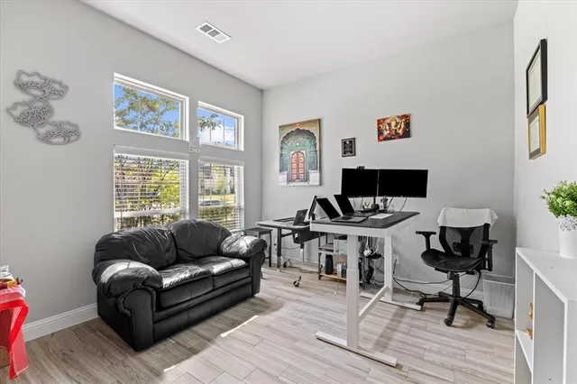 a living room with furniture a rug and a window