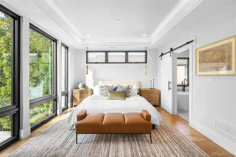 a bedroom with a large bed and a large window