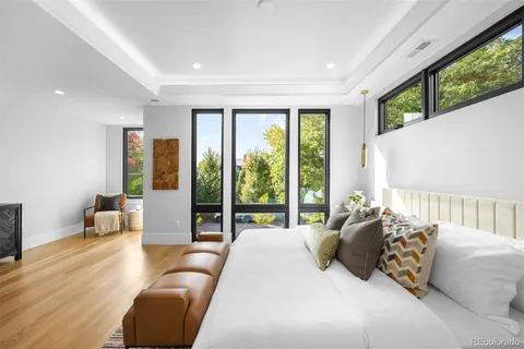 a bedroom with a large bed and a large window