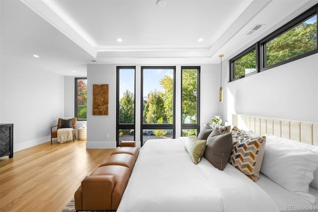 a bedroom with a large bed and a large window