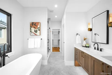 a spacious bathroom with a double vanity sink and a mirror