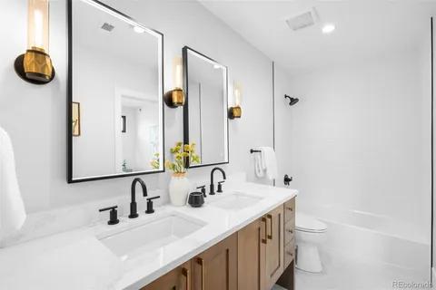 a bathroom with a double vanity sink and a mirror
